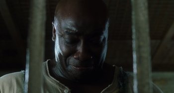 Movie still from “The Green Mile” (1999), directed by Frank Darabont – A person's face in a dark room; Close Up shot, Low angle