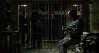 Movie still from “The Green Mile” (1999), directed by Frank Darabont – A man sitting in front of a jail cell; Wide shot, High angle