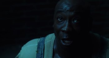 Movie still from “The Green Mile” (1999), directed by Frank Darabont – A man's face in the dark; Close Up shot, High angle