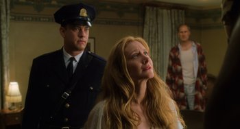 Movie still from “The Green Mile” (1999), directed by Frank Darabont – A man and a woman standing next to each other in a room; Medium shot, Low angle