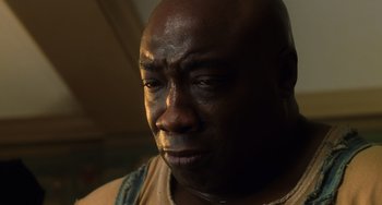 Movie still from “The Green Mile” (1999), directed by Frank Darabont – A person with a sad look on his face; Close Up shot, Low angle