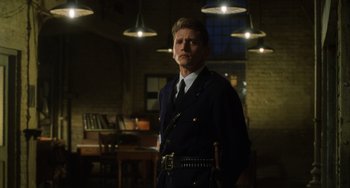 Movie still from “The Green Mile” (1999), directed by Frank Darabont – A man in a uniform standing in front of a table; Medium shot, Low angle