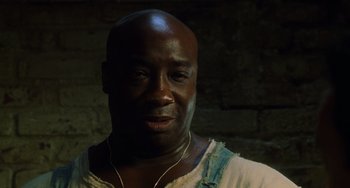 Movie still from “The Green Mile” (1999), directed by Frank Darabont – A man with a beard is smiling for the camera; Close Up shot, Low angle