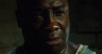 Movie still from “The Green Mile” (1999), directed by Frank Darabont – A man's face in the dark; Close Up shot, Low angle