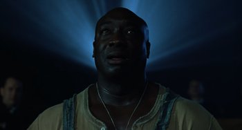 Movie still from “The Green Mile” (1999), directed by Frank Darabont – A person with a light in the background; Close Up shot, Low angle