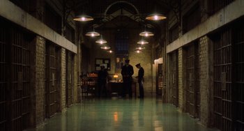 Movie still from “The Green Mile” (1999), directed by Frank Darabont – Three men standing in a large room with lights above them; Extreme Wide shot, Low angle