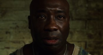 Movie still from “The Green Mile” (1999), directed by Frank Darabont – A person with a crying face; Close Up shot, Low angle