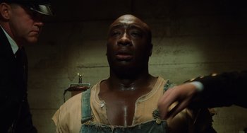 Movie still from “The Green Mile” (1999), directed by Frank Darabont – A man with a beard is looking into the camera; Close Up shot, High angle
