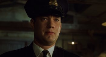 Movie still from “The Green Mile” (1999), directed by Frank Darabont – A man in a police officer's uniform looking into the camera; Close Up shot, Low angle
