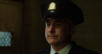 Movie still from “The Green Mile” (1999), directed by Frank Darabont – A man in a police officer's uniform is looking to his left; Close Up shot, Low angle