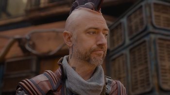 Movie still from “The Guardians of the Galaxy Holiday Special” (2022), directed by James Gunn – A man with a mohawk and a beard; Close Up shot, Over the shoulder angle