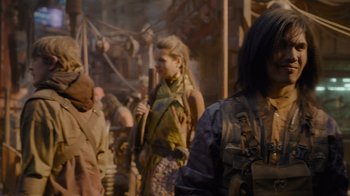 Movie still from “The Guardians of the Galaxy Holiday Special” (2022), directed by James Gunn – A group of people standing next to each other on a street; Medium shot, Over the shoulder angle