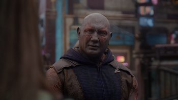 Movie still from “The Guardians of the Galaxy Holiday Special” (2022), directed by James Gunn – A bald man in a leather jacket and a hood is looking at the camera; Close Up shot, Over the shoulder angle
