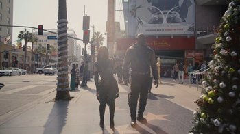 Movie still from “The Guardians of the Galaxy Holiday Special” (2022), directed by James Gunn – A man and a woman walking down a street; Wide shot, Low angle