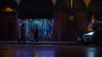 Movie still from “The Guardians of the Galaxy Holiday Special” (2022), directed by James Gunn – A group of people standing on the side of the street; Extreme Wide shot, Low angle