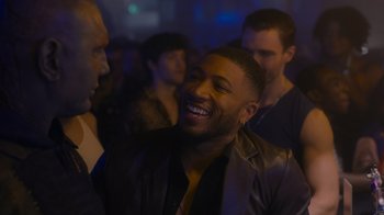 Movie still from “The Guardians of the Galaxy Holiday Special” (2022), directed by James Gunn – A group of men standing around a room; Close Up shot, Over the shoulder angle