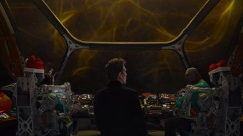 Movie still from “The Guardians of the Galaxy Holiday Special” (2022), directed by James Gunn – A group of people sitting in front of a space ship; Wide shot, High angle