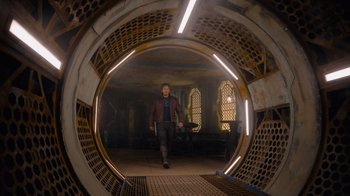 Movie still from “The Guardians of the Galaxy Holiday Special” (2022), directed by James Gunn – A man is walking through a tunnel in a building; Wide shot, Low angle
