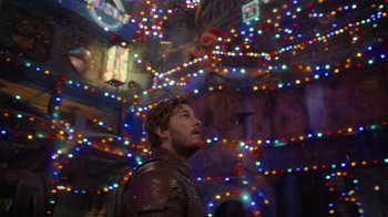 Movie still from “The Guardians of the Galaxy Holiday Special” (2022), directed by James Gunn – A man standing in front of a room with lights; Medium shot, Low angle