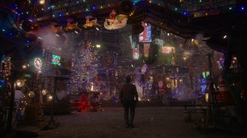 Movie still from “The Guardians of the Galaxy Holiday Special” (2022), directed by James Gunn – A person standing in a room filled with christmas lights; Extreme Wide shot, High angle