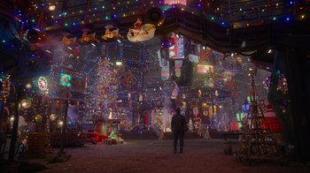 Movie still from “The Guardians of the Galaxy Holiday Special” (2022), directed by James Gunn – A person standing in a room with christmas decorations; Extreme Wide shot, High angle