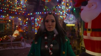 Movie still from “The Guardians of the Galaxy Holiday Special” (2022), directed by James Gunn – A woman wearing a green coat and a green jacket; Close Up shot, Over the shoulder angle
