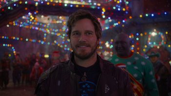 Movie still from “The Guardians of the Galaxy Holiday Special” (2022), directed by James Gunn – A person wearing a jacket with lights in the background; Close Up shot, Over the shoulder angle
