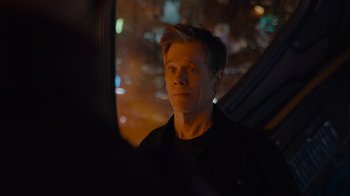 Movie still from “The Guardians of the Galaxy Holiday Special” (2022), directed by James Gunn – A man looking out of a car window at night; Close Up shot, Over the shoulder angle