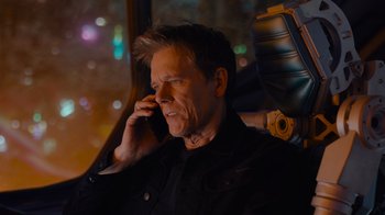 Movie still from “The Guardians of the Galaxy Holiday Special” (2022), directed by James Gunn – A man talking on a cell phone while sitting in a car; Close Up shot, High angle