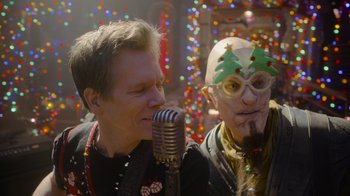 Movie still from “The Guardians of the Galaxy Holiday Special” (2022), directed by James Gunn – A man and a man with a christmas tree hat on; Close Up shot, Over the shoulder angle