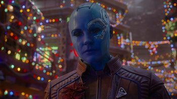 Movie still from “The Guardians of the Galaxy Holiday Special” (2022), directed by James Gunn – A person wearing a blue and brown suit and a mask; Close Up shot, Over the shoulder angle