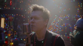 Movie still from “The Guardians of the Galaxy Holiday Special” (2022), directed by James Gunn – A man holding a microphone up to his mouth; Close Up shot, Low angle