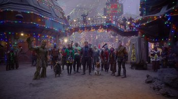 Movie still from “The Guardians of the Galaxy Holiday Special” (2022), directed by James Gunn – A group of people standing next to each other on a street; Extreme Wide shot, Low angle