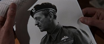 Movie still from “The Guns of Navarone” (1961), directed by J. Lee Thompson – An old black and white photo of a man in a military uniform; Close Up shot, Low angle