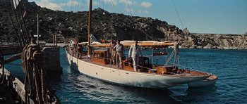 Movie still from “The Guns of Navarone” (1961), directed by J. Lee Thompson – A group of men standing on the deck of a sail boat; Wide shot, High angle