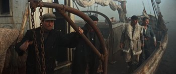 Movie still from “The Guns of Navarone” (1961), directed by J. Lee Thompson – A group of men standing next to each other on a boat; Medium shot, Low angle