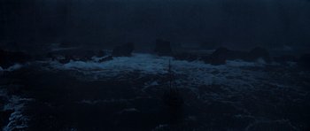 Movie still from “The Guns of Navarone” (1961), directed by J. Lee Thompson – A boat in the middle of the ocean at night; Extreme Wide shot, High angle