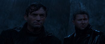 Movie still from “The Guns of Navarone” (1961), directed by J. Lee Thompson – Two men standing next to each other in the rain; Close Up shot, Low angle