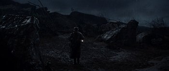 Movie still from “The Guns of Navarone” (1961), directed by J. Lee Thompson – A man standing in the dark holding a flashlight; Extreme Wide shot, High angle