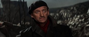 Movie still from “The Guns of Navarone” (1961), directed by J. Lee Thompson – A person wearing a jacket and hat; Close Up shot, Low angle