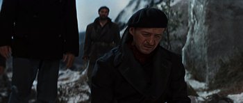 Movie still from “The Guns of Navarone” (1961), directed by J. Lee Thompson – A man in a black coat and a man in a black hat; Medium shot, Low angle