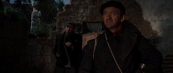 Movie still from “The Guns of Navarone” (1961), directed by J. Lee Thompson – Two men are standing next to each other; Medium shot, Low angle