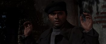 Movie still from “The Guns of Navarone” (1961), directed by J. Lee Thompson – A person wearing a hat and a coat; Close Up shot, High angle