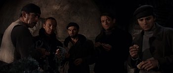 Movie still from “The Guns of Navarone” (1961), directed by J. Lee Thompson – A group of men standing next to each other in the dark; Medium shot, Low angle