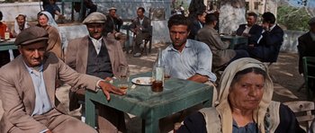 Movie still from “The Guns of Navarone” (1961), directed by J. Lee Thompson – A group of men sitting at a table with drinks; Wide shot, High angle