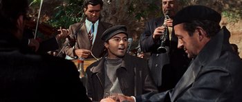 Movie still from “The Guns of Navarone” (1961), directed by J. Lee Thompson – A group of men standing next to each other on a stage; Medium shot, Over the shoulder angle