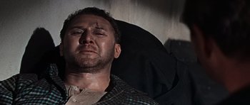 Movie still from “The Guns of Navarone” (1961), directed by J. Lee Thompson – A person laying in a chair; Close Up shot, Low angle