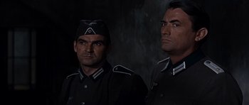 Movie still from “The Guns of Navarone” (1961), directed by J. Lee Thompson – A couple of men standing next to each other; Close Up shot, Low angle
