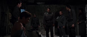 Movie still from “The Guns of Navarone” (1961), directed by J. Lee Thompson – A group of men in uniforms standing next to each other; Wide shot, Low angle