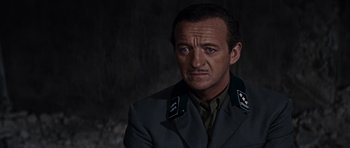 Movie still from “The Guns of Navarone” (1961), directed by J. Lee Thompson – A man in a military uniform is looking at the camera; Close Up shot, Low angle